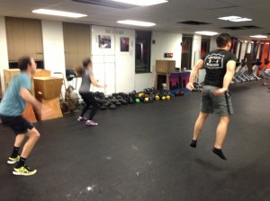 Members of the RRC getting in a quick AMRAP of jumping jacks, jump squats, and push ups pre-Rowing WOD